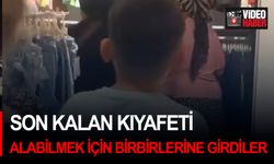 Son kalan kıyafeti alabilmek için birbirlerine girdiler